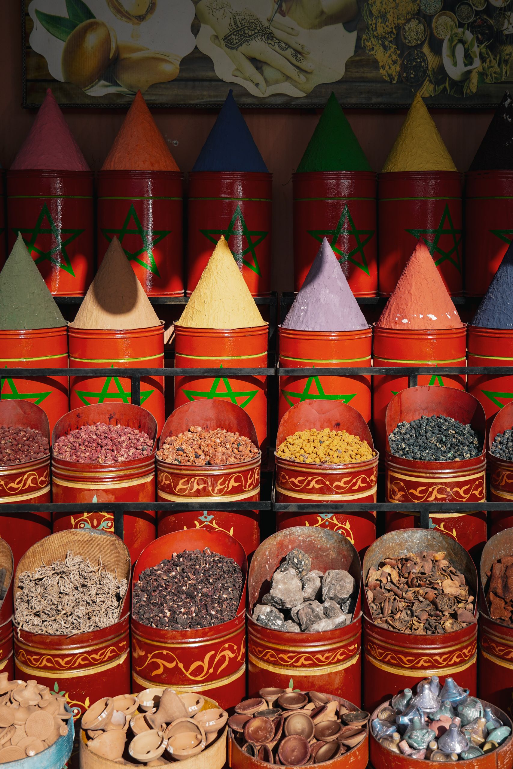 Colorful spice display at a market in Marrakech, Morocco, showcasing exotic varieties.