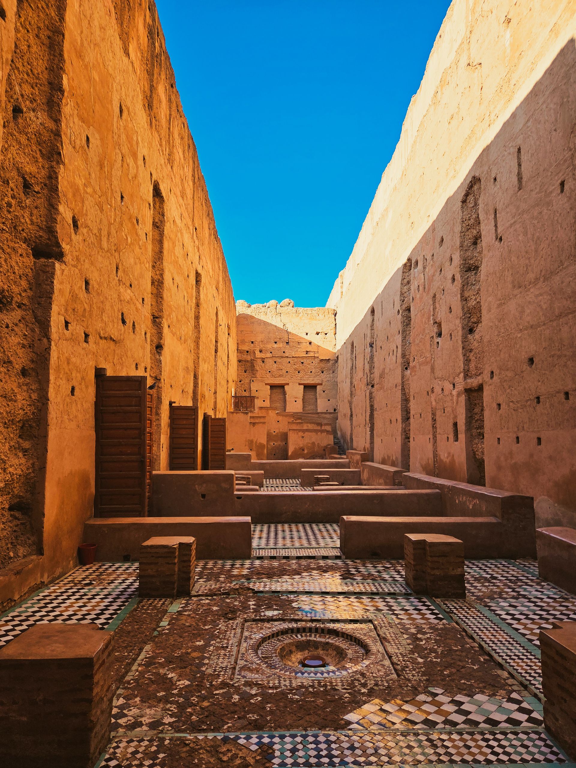 Historic Moroccan architecture under clear blue sky in Marrakech.